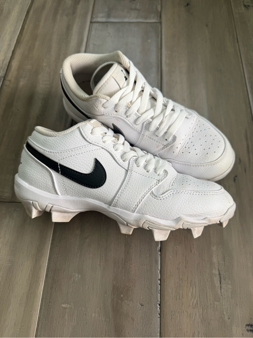 Nike Kids Jordan 1 Low White cleats with Black Swoosh
